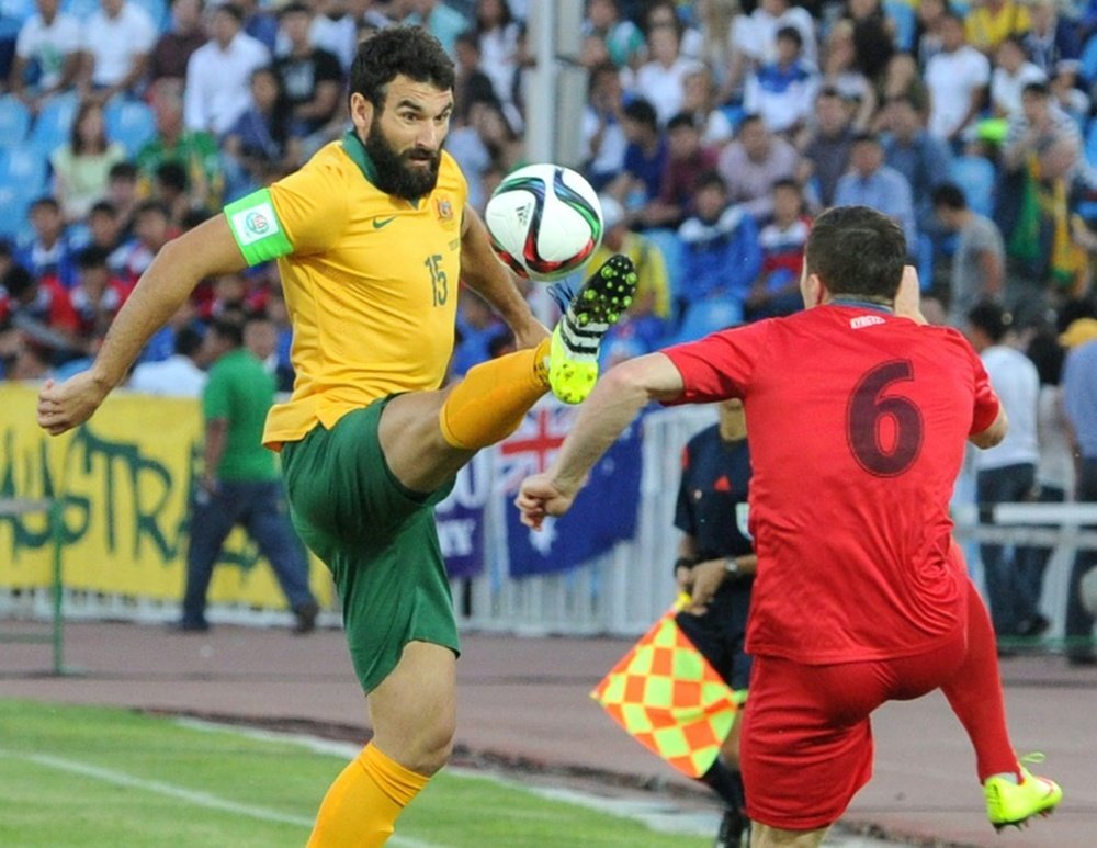 Australias Mile Jedinak (L) at the FIFA World Cup 2018 Group B qualifying match against Kyrgyzstan