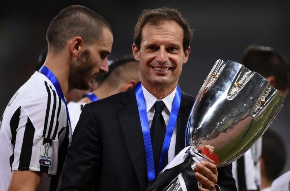Allegri posing with a trophy. AFP