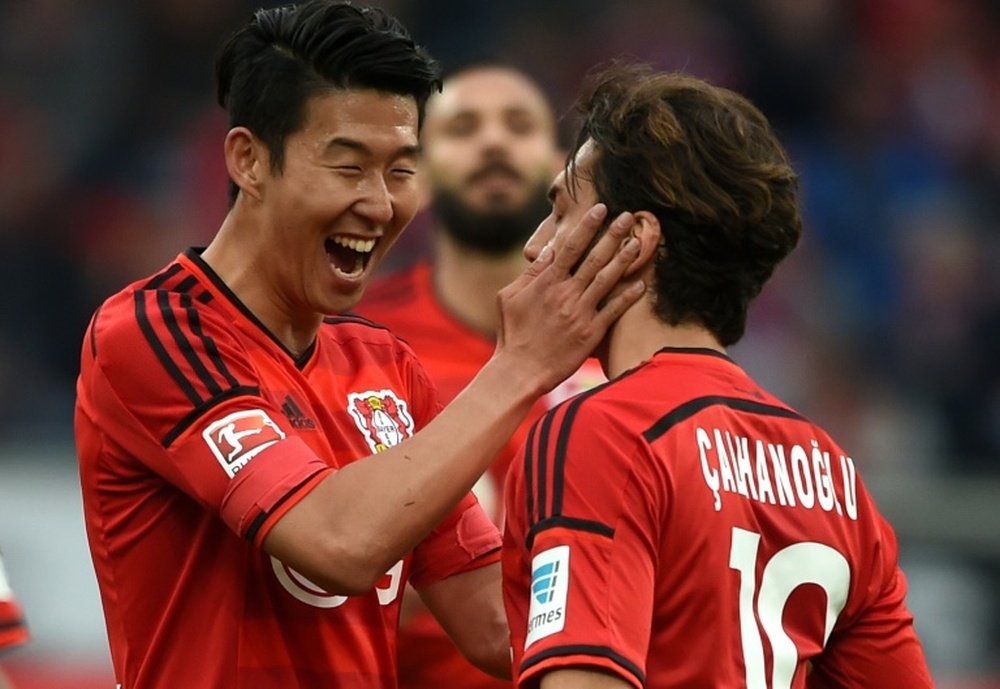 Leverkusens Hakan Calhanoglu (R) celebrates scoring a goal with teammate Son Heung-Min during a German first division Bundesliga match at the BayArena in Leverkusen, western Germany, in May 2015