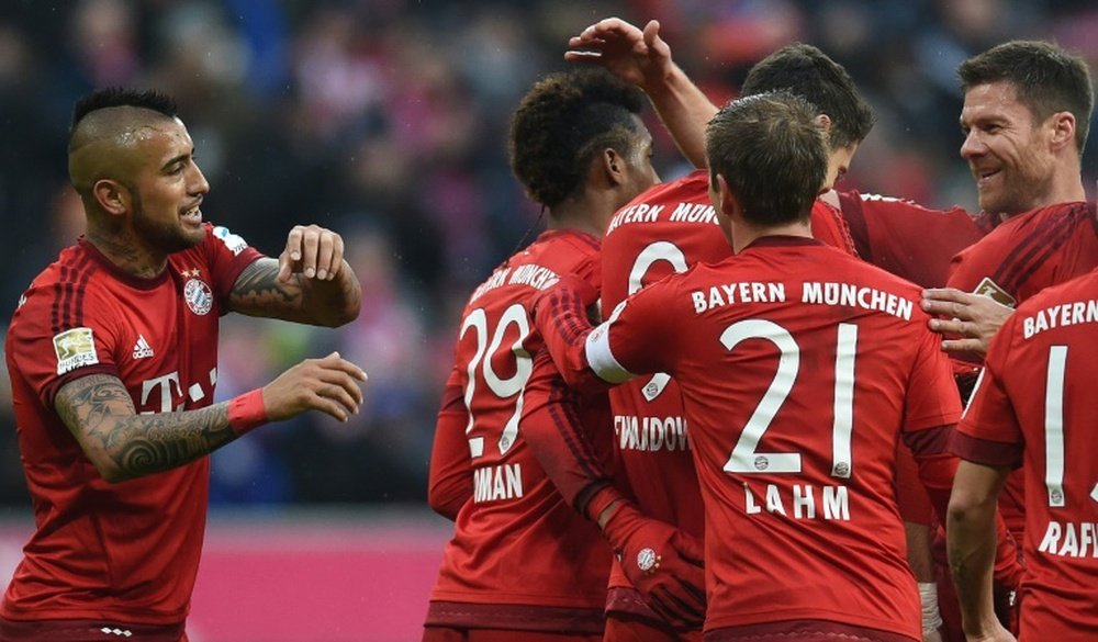Bayern Munich players celebrate after the second goal during their Bundesliga match against Hertha Berlin in Munich on November 28, 2015