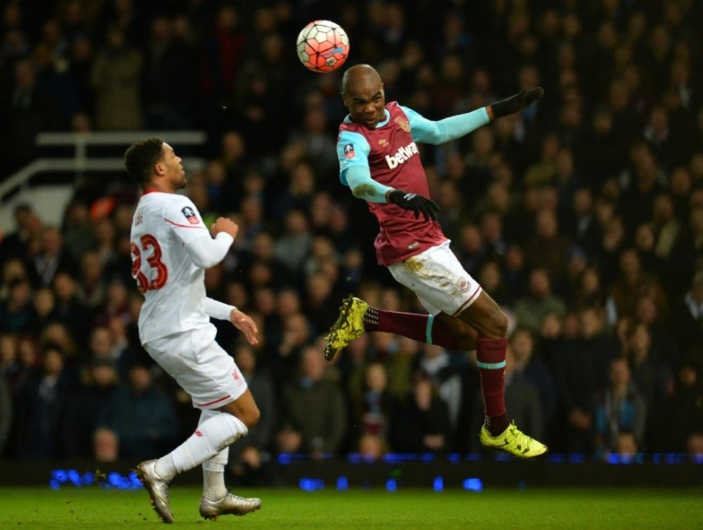 West Ham Uniteds defender Angelo Ogbonna (R) heads the ball during the English FA Cup fourth round replay match against Liverpool in Upton Park, east London, on February 9, 2016
