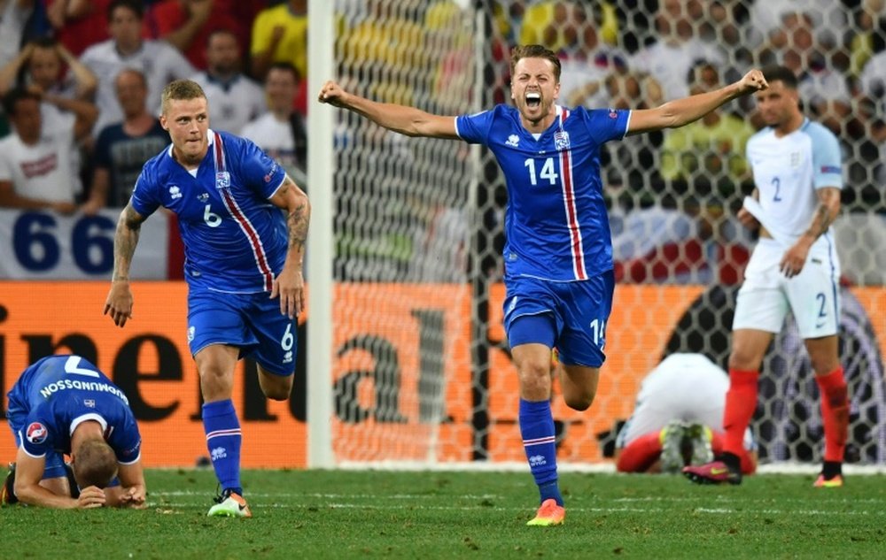 (L to R) Icelands defender Ragnar Sigurdsson and teammate Kari Arnason celebrate their teams 2-1 win in a Euro 2016 round of 16 football match against England at the Allianz Riviera stadium in Nice on June 27, 2016