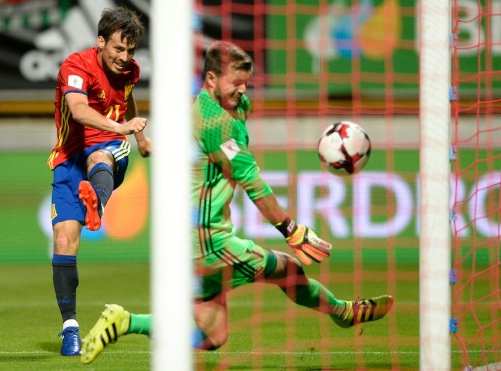 Spains midfielder David Silva shoots against Liechtensteins goalkeeper Peter Jehle on September 5, 2016