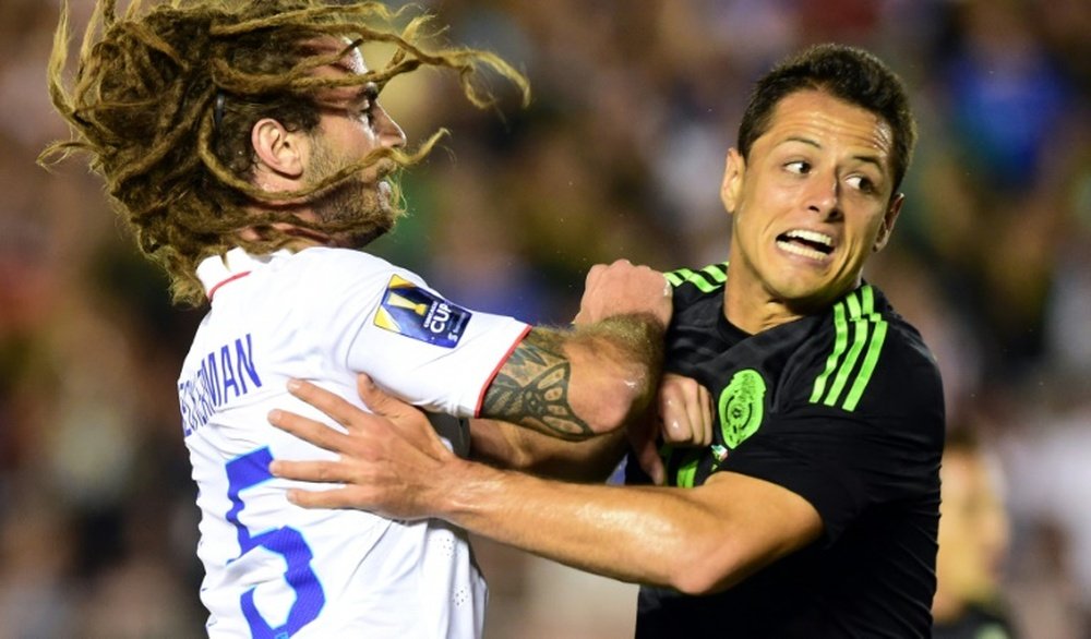 Javier Hernandez (R) of Mexico collides with Kyle Beckerman of the US during their CONCACAF Cup match at the Rose Bowl in Pasadena, California, on October 10, 2015