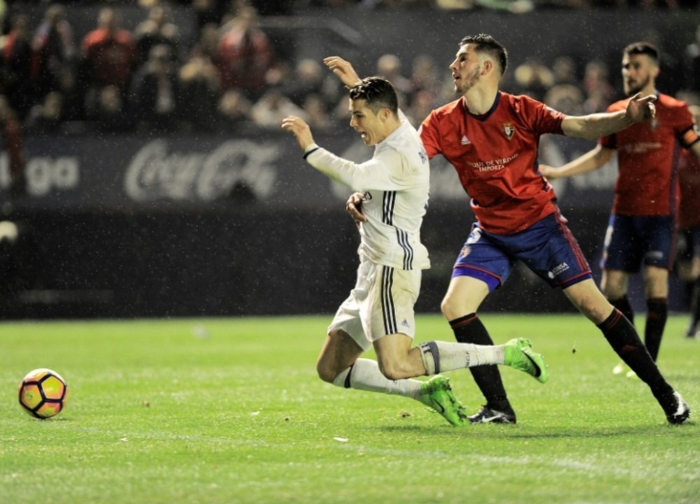Cristiano Ronaldo (left) suffered a heavy tackle against Osasuna at the weekend. AFP