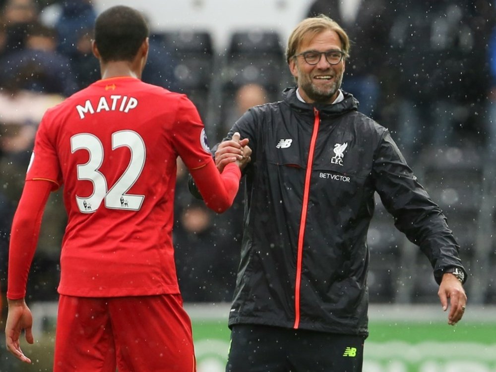 Liverpools manager Jurgen Klopp (R) congratulates defender Joel Matip at the end of their English Premier League match against Swansea City, at The Liberty Stadium in Swansea, south Wales, on October 1, 2016
