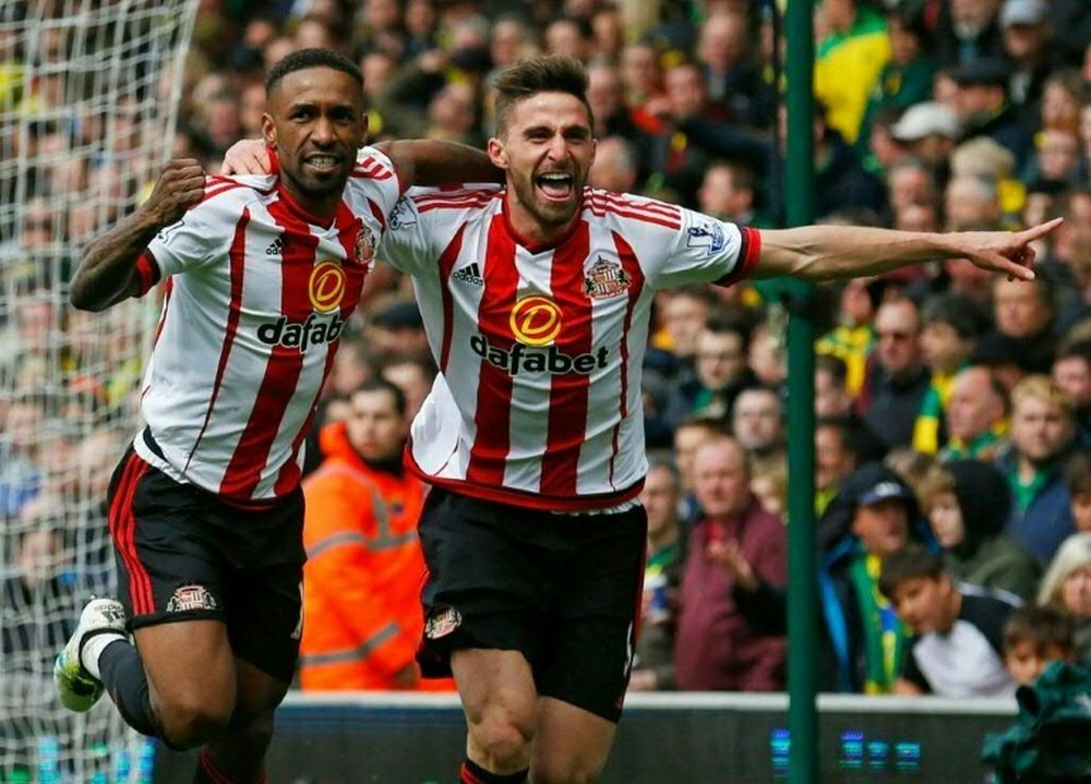 Sunderland striker Jermain Defoe (L) celebrates with teammate Fabio Borini after scoring their second goal during the English Premier League match against Norwich City at Carrow Road in Norwich, eastern England, on April 16, 2016