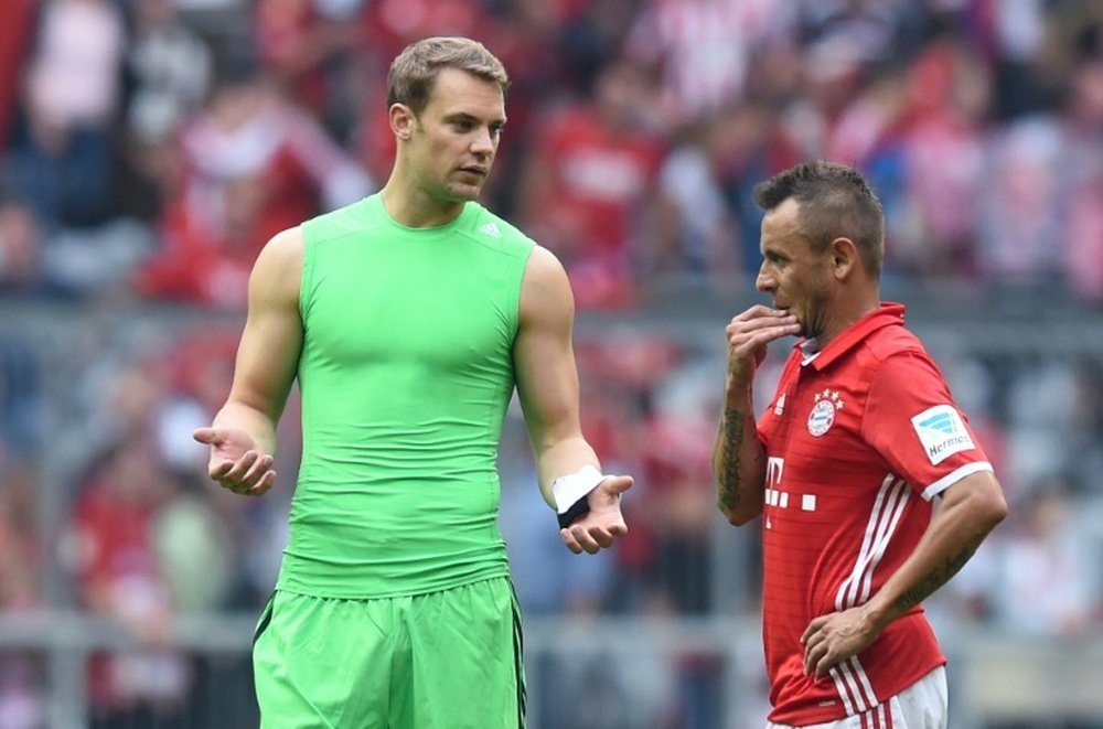 Bayern Munichs goalkeeper Manuel Neuer (L) and his teammate Brazilian defender Rafinha speak together after their German first division Bundesliga football match against Cologne in Munich, southern Germany, on October 1, 2016