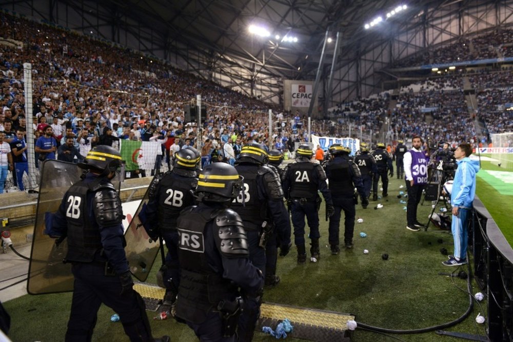 Riot police are pictured during a game interruption at the French L1 football match Marseille vs Lyon on September 20, 2015 at Velodrome Stadium