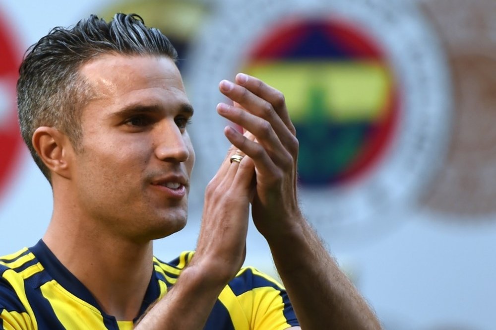 Robin Van Persie saluts Fenerbahces fans during a signing ceremony with the Turkish Super Lig giants at the Sukru Saracoglu stadium in Istanbul on July 14, 2015