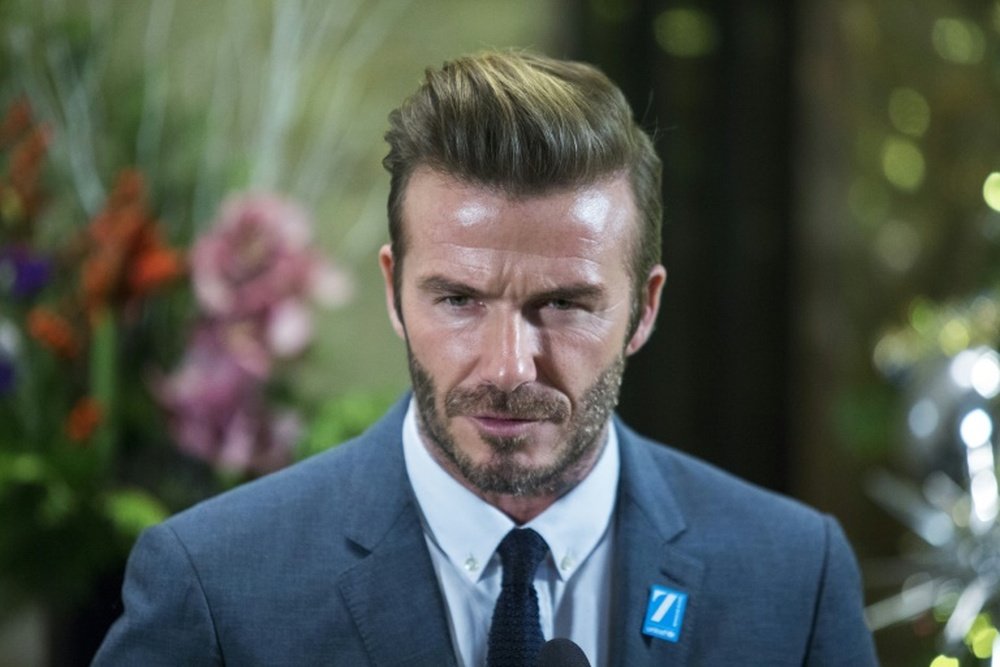 David Beckham was one of three United legends to visit Eric Harrison. AFP
