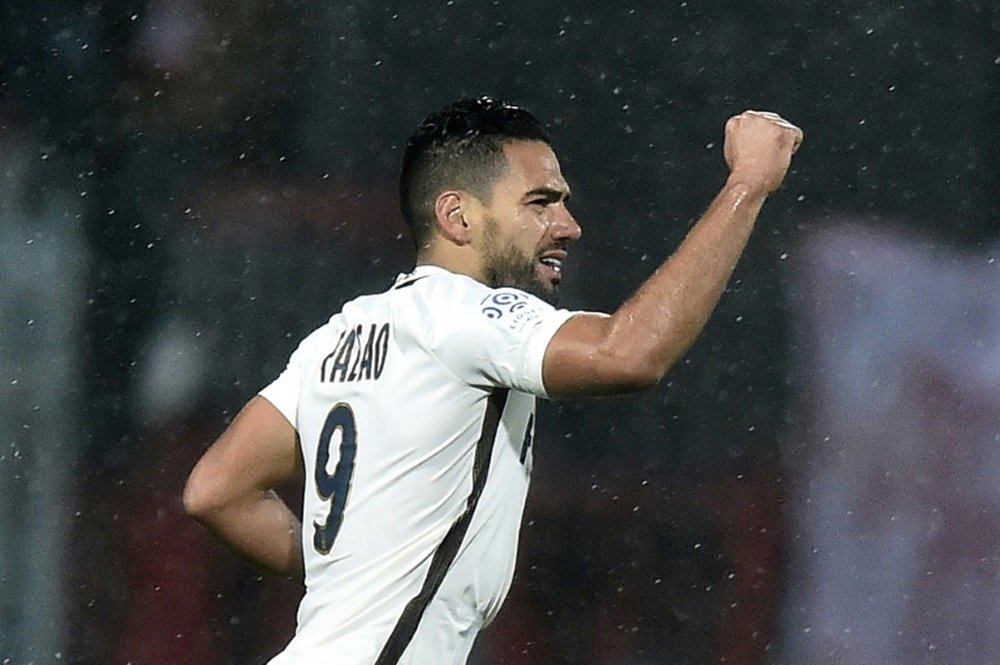Monacos Colombian forward Radamel Falcao raises his fist as he celebrates after scoring during the French L1 football match between Lorient and Monaco on November 18, 2016 at the Moustoir stadium of Lorient, western France