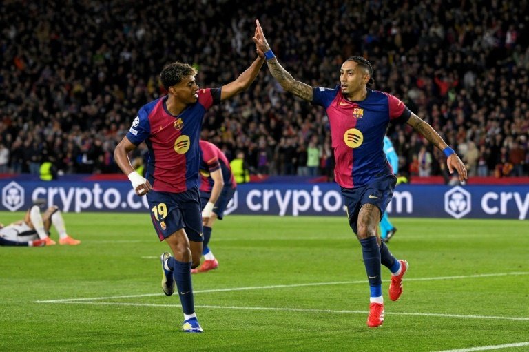 Raphinha (R) netted a brace in Barcelona's 3-1 victory over Benfica. AFP