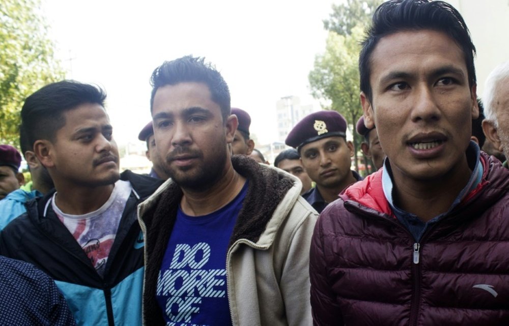 Nepalese footballers Sagar Thapa (R), Ritesh Thapa (C) and Sandip Rai (L) arrive at a Special Court in Kathmandu on October 27, 2015 as part of the match-fixing scandal that has hit the national team