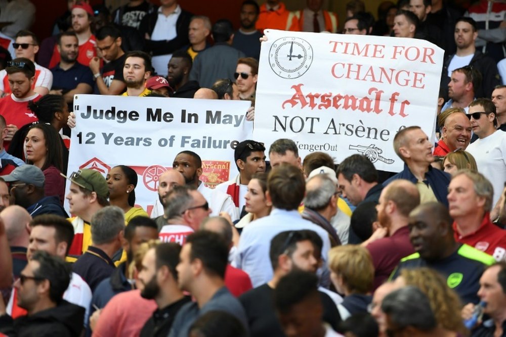 Fans hold up banners calling for a managerial change at Arsenal on May 21, 2017