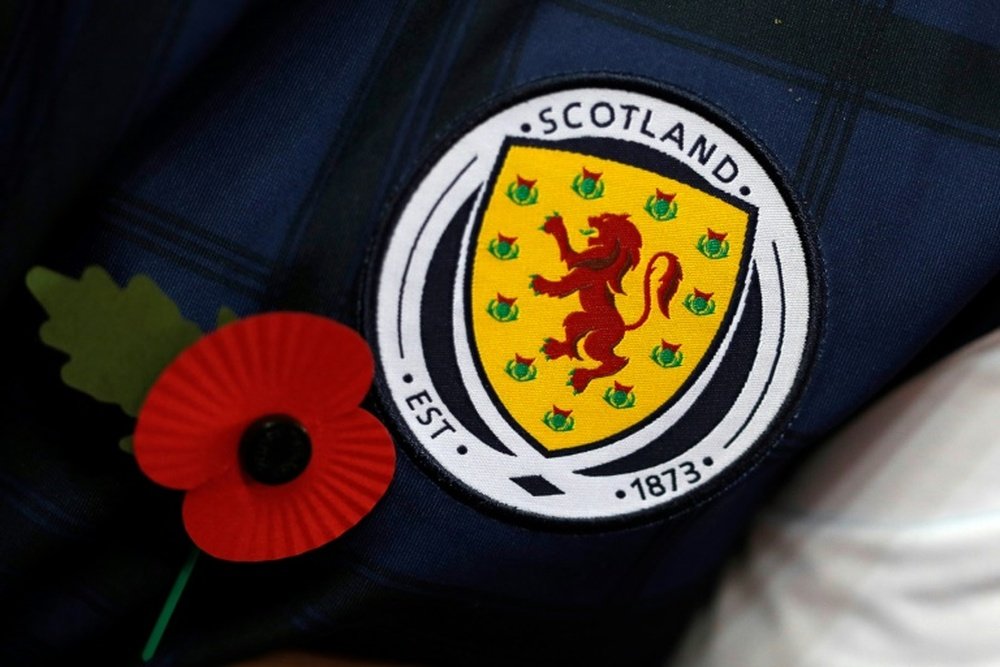 A Scottish supporter wears a jacket with a red poppy to pay respect to the country's war dead. AFP