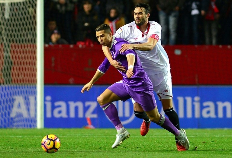 Sevilla's midfielder Vicente Iborra (R) vies with Real Madrid's Cristiano Ronaldo. AFP