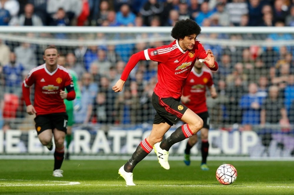 Manchester Uniteds midfielder Marouane Fellaini (R) runs onto the ball during the English FA Cup semi-final football match between Everton and Manchester United at Wembley Stadium in London on April 23, 2016