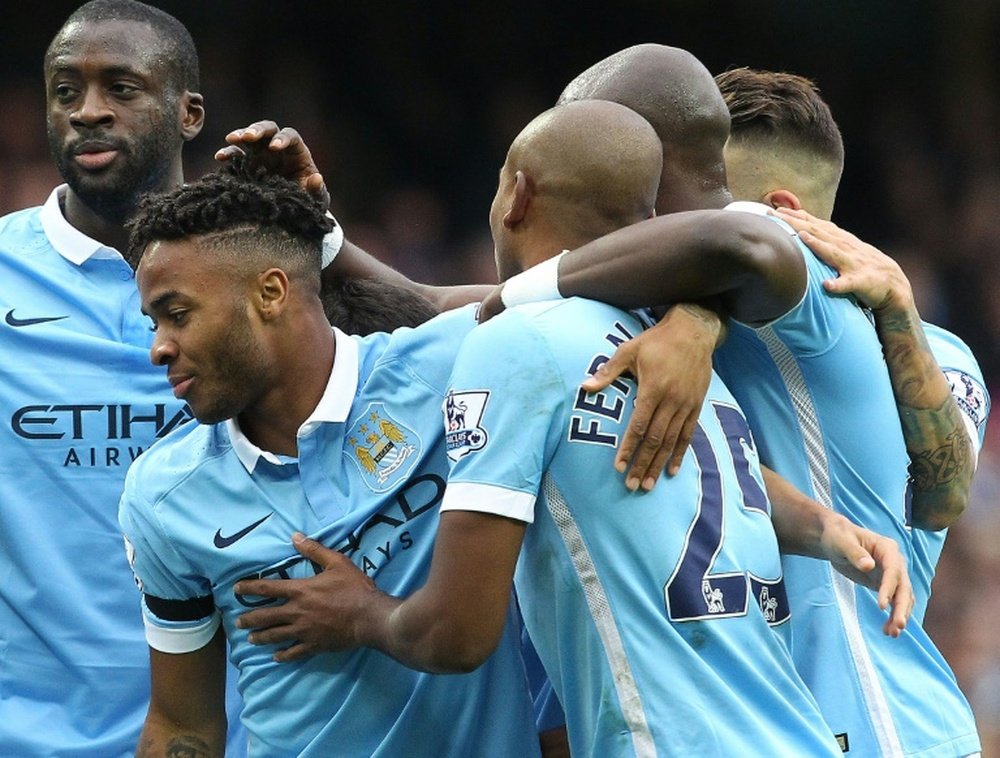 Manchester City midfielder Raheem Sterling (2nd L) celebrates with teammates after scoring the opening goal of the Premier League match against Bournemouth at Etihad Stadium on October 17, 2015