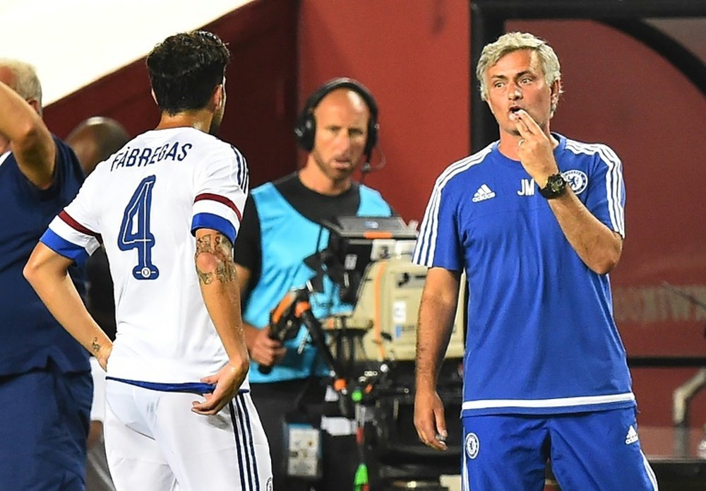 Chelsea coach Jose Mourinho (R) speaks to player Cesc Fabregas during an International Champions Cup match in Landover, Maryland, on July 28, 2015