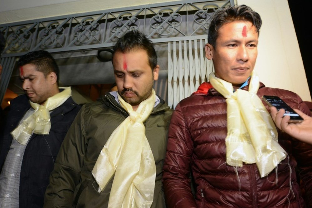 Nepalese footballers Sagar Thapa (R), Anjam KC (C) and Bikash Singh Chhetri (L) talk with the media outside a special court in Kathmandu on November 10, 2015