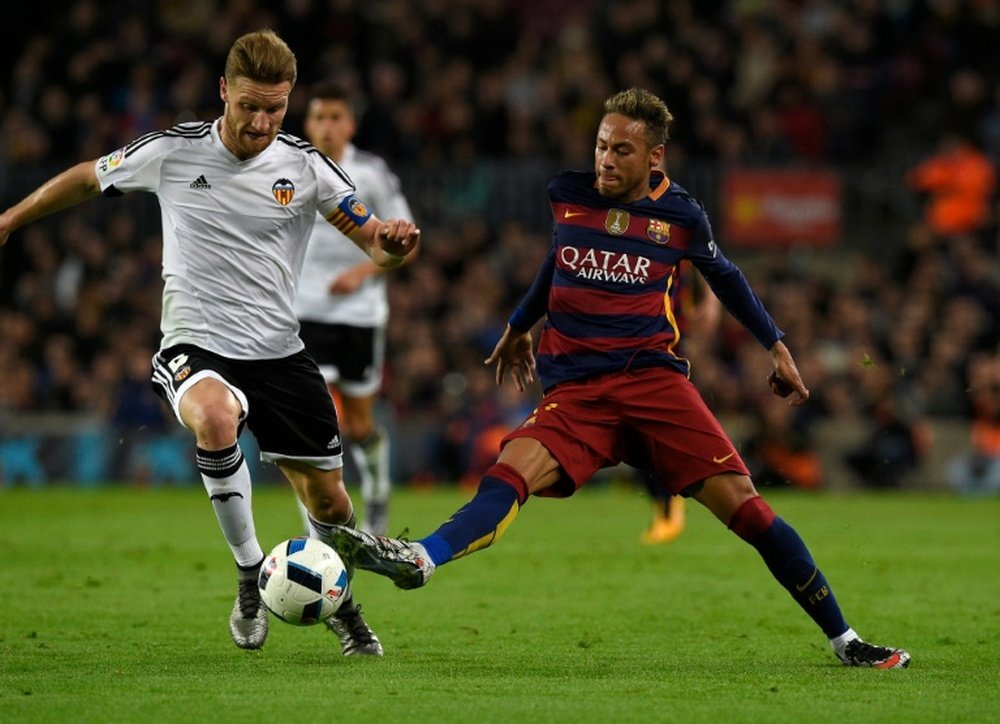 Mustafi (L) in action against Barcelona. AFP