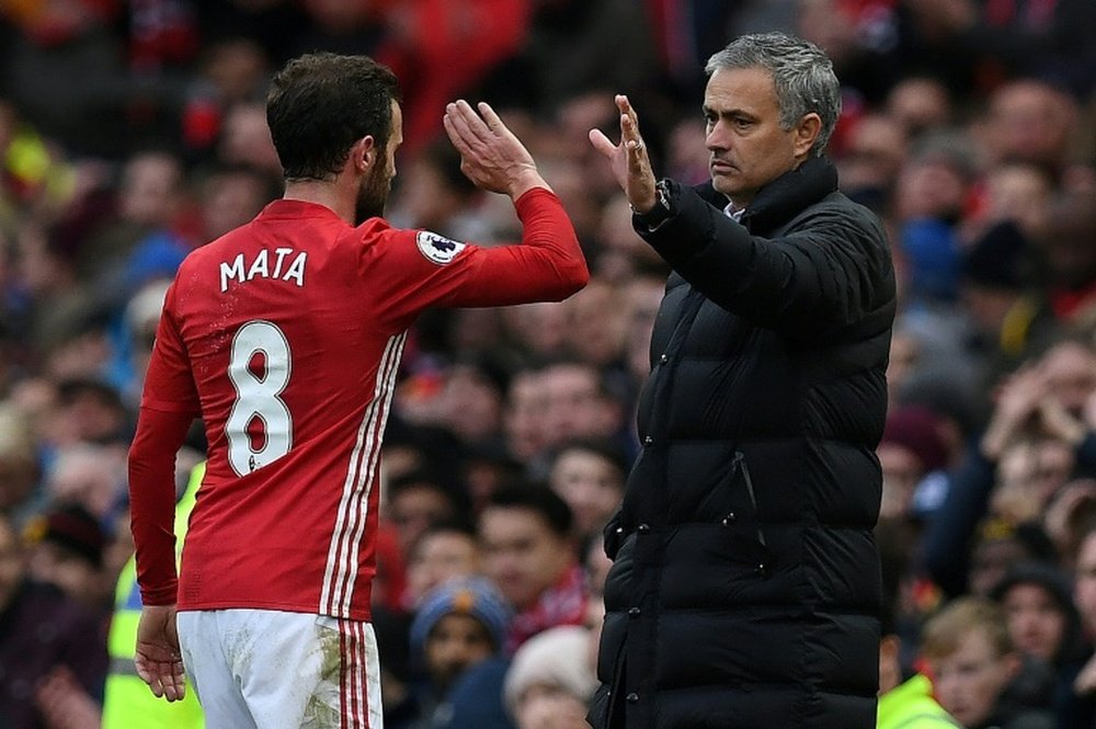 Mata congratulated by Mourinho. AFP