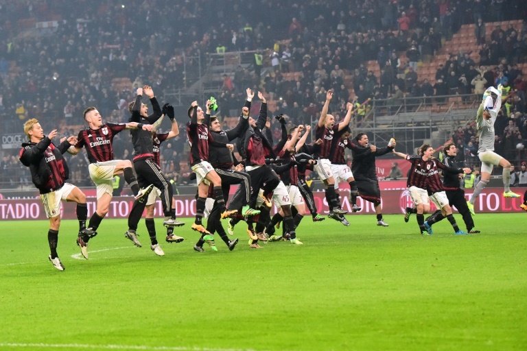 AC Milans players celebrate at the end of their Italian Serie A football match against Inter Milan at San Siro Stadium in Milan on January 31, 2015