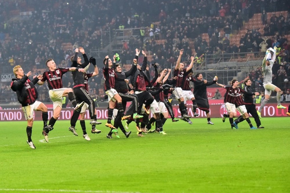 AC Milans players celebrate at the end of their Italian Serie A football match against Inter Milan at San Siro Stadium in Milan on January 31, 2015