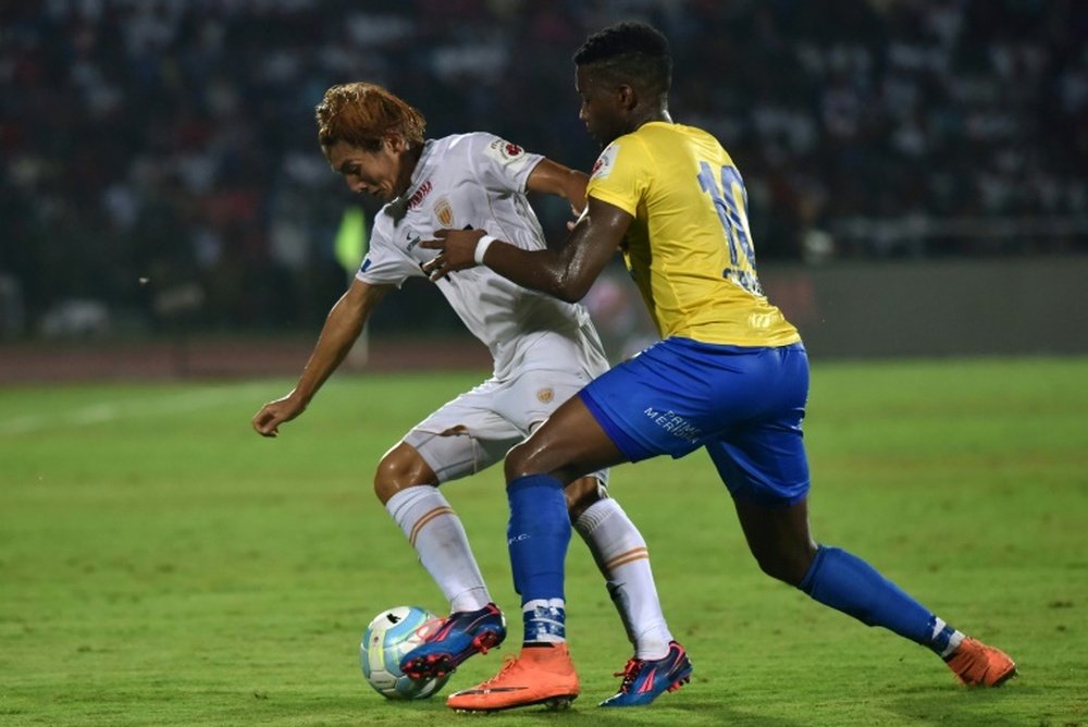 Kerala Blasters FCs forward Antonio German (R) challenges Northeast United FCs midfielder Katsumi Yusa for the ball during the Indian Super League football match between Northeast United FC and Kerala Blasters FC