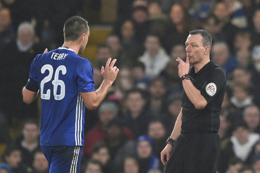 Chelsea defender John Terry (L) reacts just before Kevin Friend shows him a red card. AFP