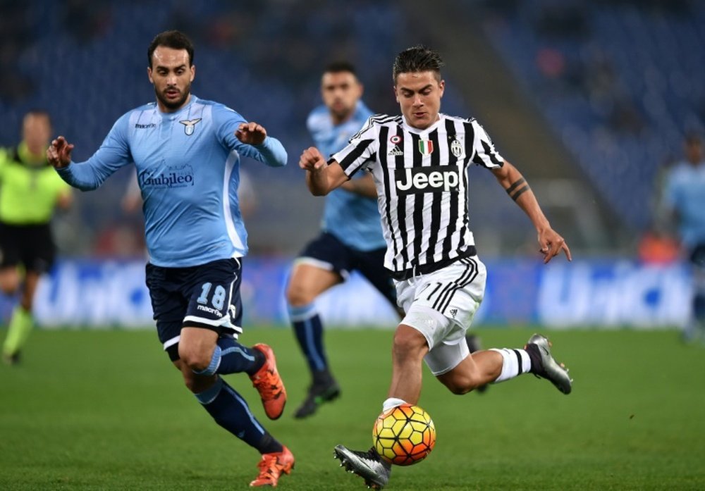 Juventus' forward from Argentina Paulo Dybala (R) vies for the ball with Lazio's defender from Argentina Santiago Gentiletti during the Italian Serie A football match on December 4, 2015 at the Olympic stadium in Rome