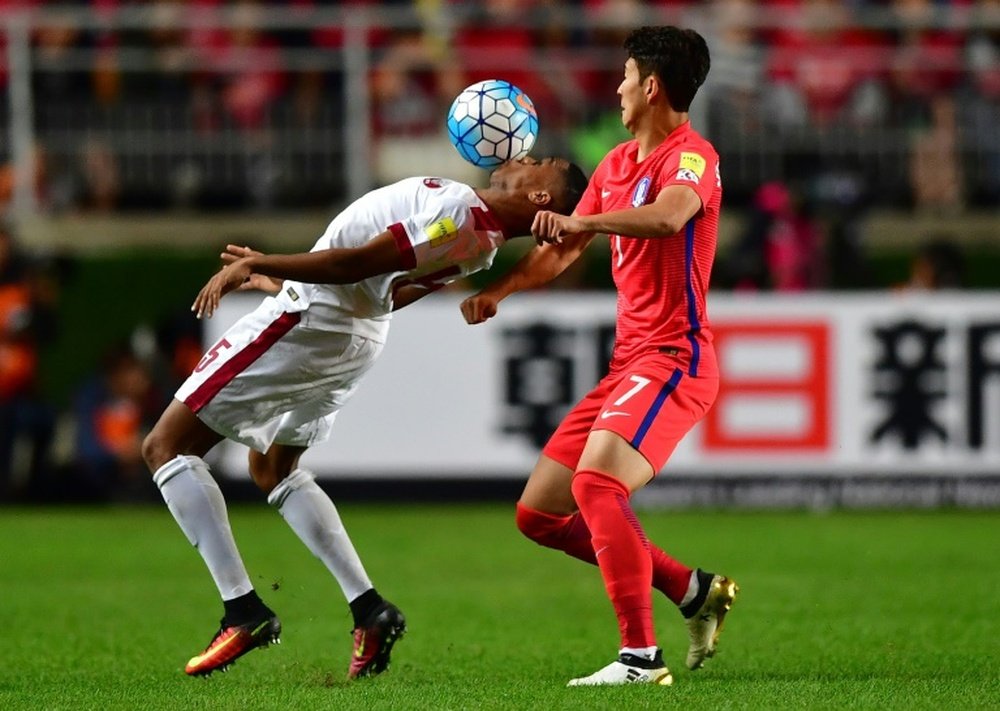 South Koreas Son Heung-Min (R) fights for the ball with Qatars Pedro Correia (L) during their 2018 World Cup qualifying match in Suwon, south of Seoul, on October 6, 2016