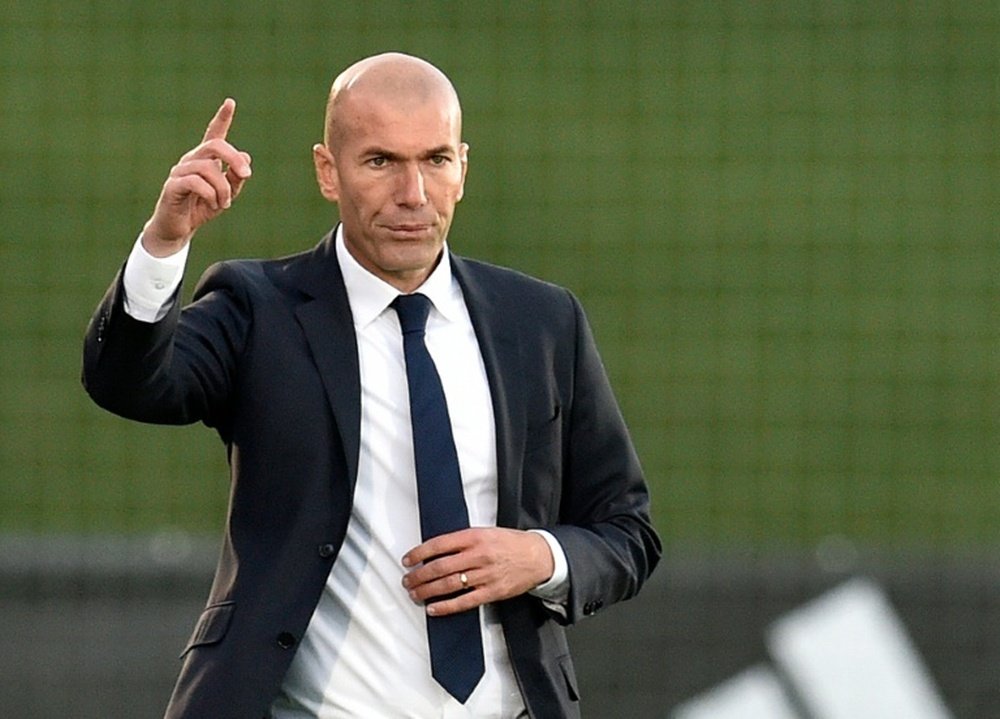 Former French football star and coach of Real Madrid Castilla Zinedine Zidane (R) gestures during the Spanish league second division football match Real Madrid Castilla vsTalavera de la Reina in Valdebebas on December 19, 2015