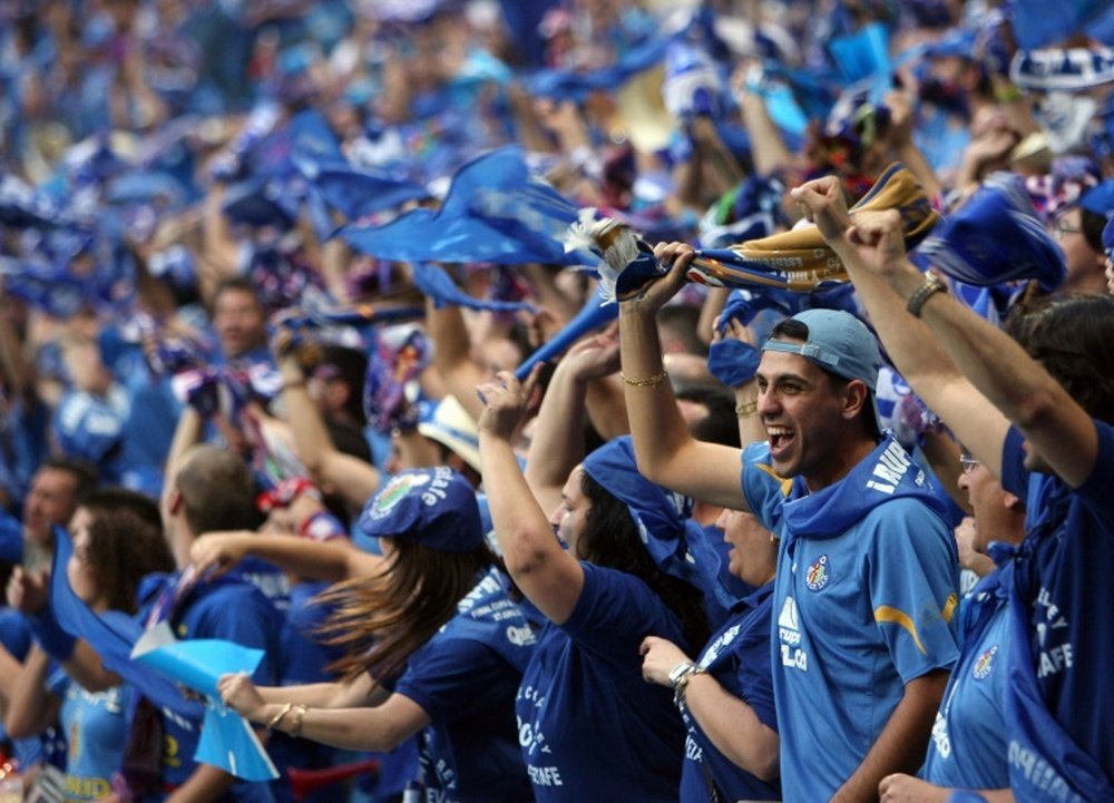 Getafe supporters cheer on their team prior to the start of the Kings Cup final between Sevilla and Getafe at the Santiago Bernabeu stadium in Madrid