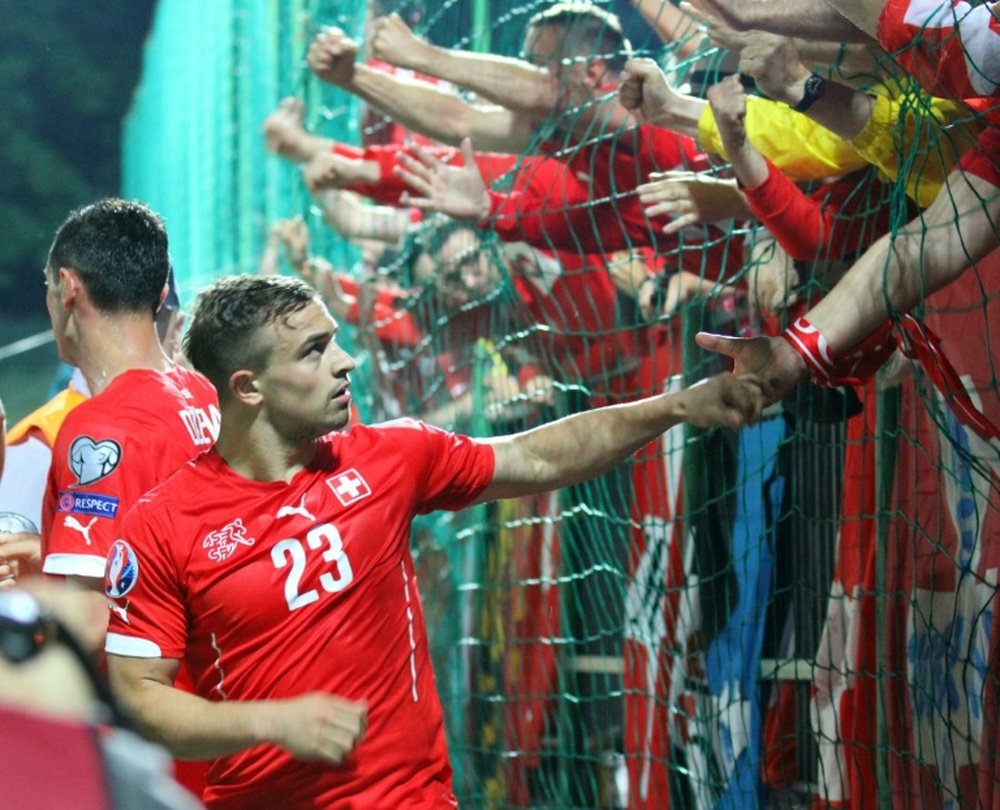 Switzerland Xherdan Shaqiri celebrates with teammates and fans after scoring during their Euro 2016 Group E qualifying football match against Lithuania in Vilnius on June 14, 2015