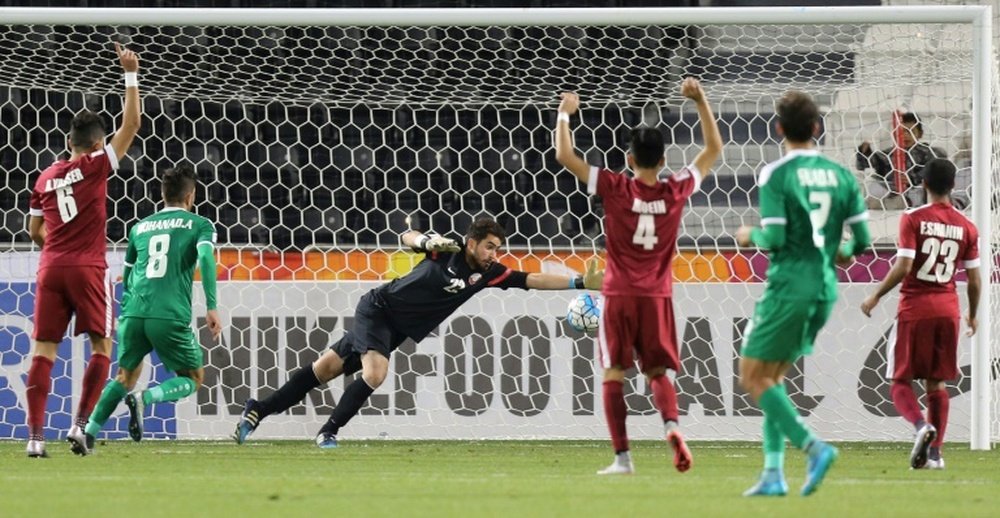 Qatars goalkeeper Muhannad Naim (C) tries to save a shot during their AFC U23 Championship 3rd place football match between Qatar and Iraq in Doha on January 29, 2016