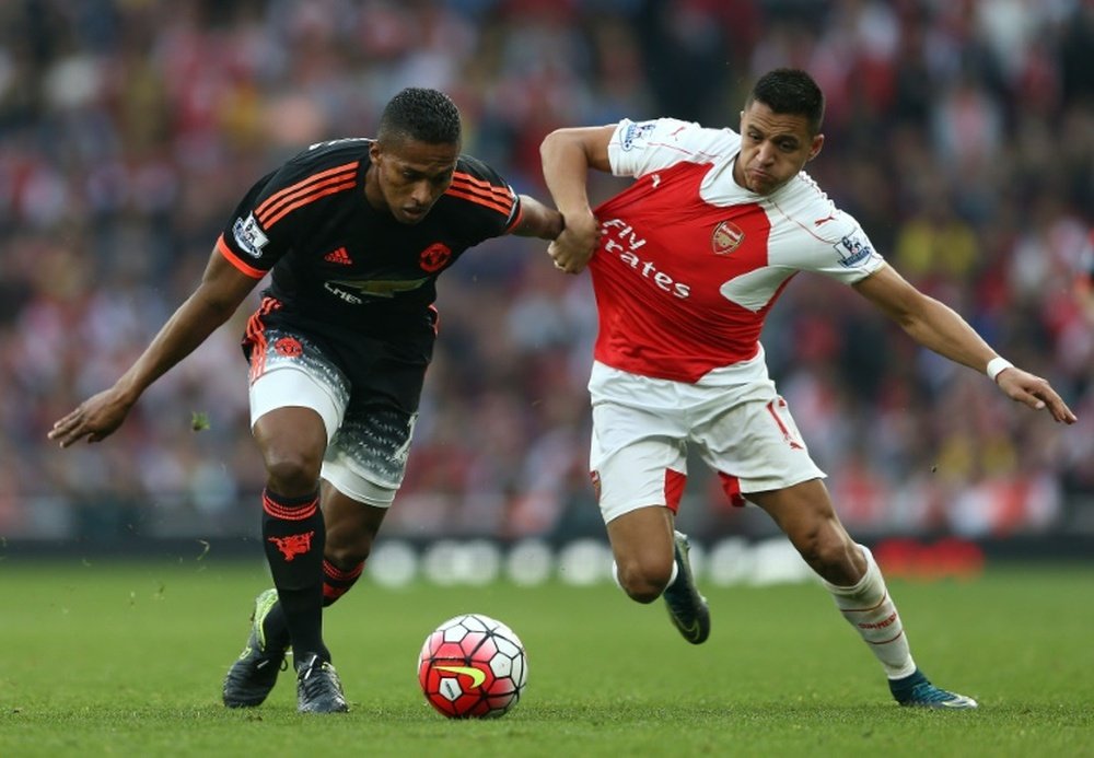 Manchester Uniteds midfielder Antonio Valencia (L) clashes with Arsenals striker Alexis Sanchez during an English Premier League football match at the Emirates Stadium in London on October 4, 2015