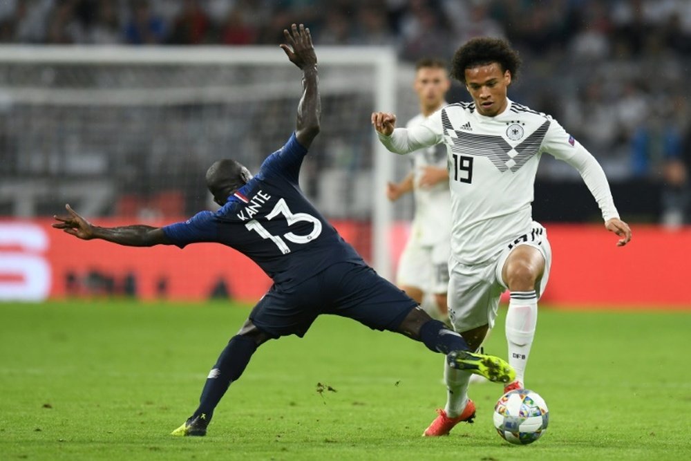 Leroy Sane hurdles a challenge from N'Golo Kante. AFP