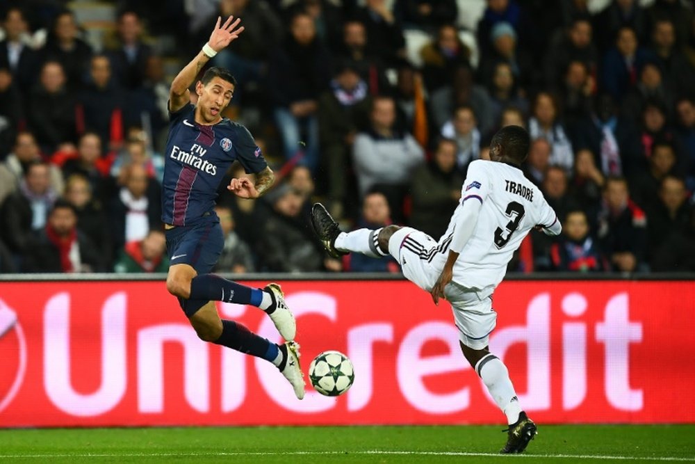 Paris Saint-Germain forward Angel Di Maria (L) challenges Basel defender Adama Traore. AFP