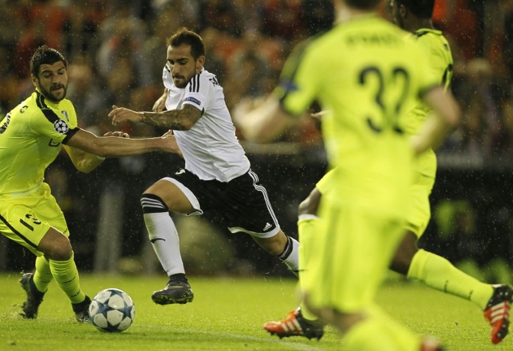 Gents Serbian defender Stefan Mitrovic (L) vies with Valencias forward Paco Alcacer during the UEFA Champions League group H football match Valencia CF vs KAA Gent at the Mestalla stadium in Valencia on October 20, 2015