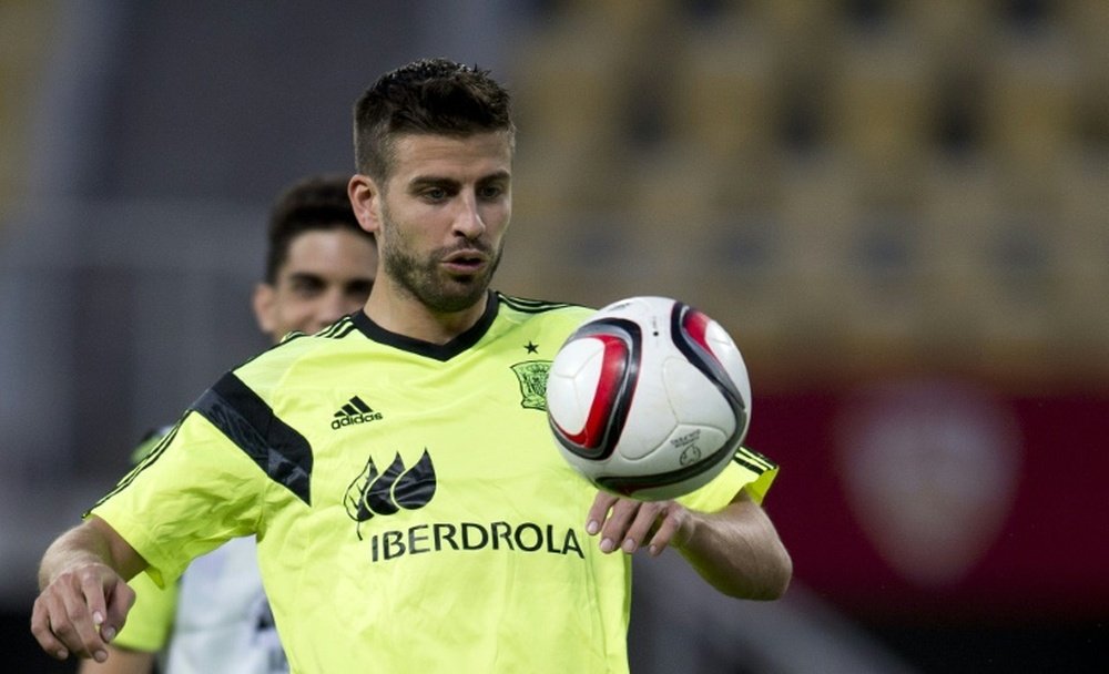 Spain defender Gerard Pique plays with a ball during a training session at the Filip II Arena stadium in Skopje on September 7, 2015