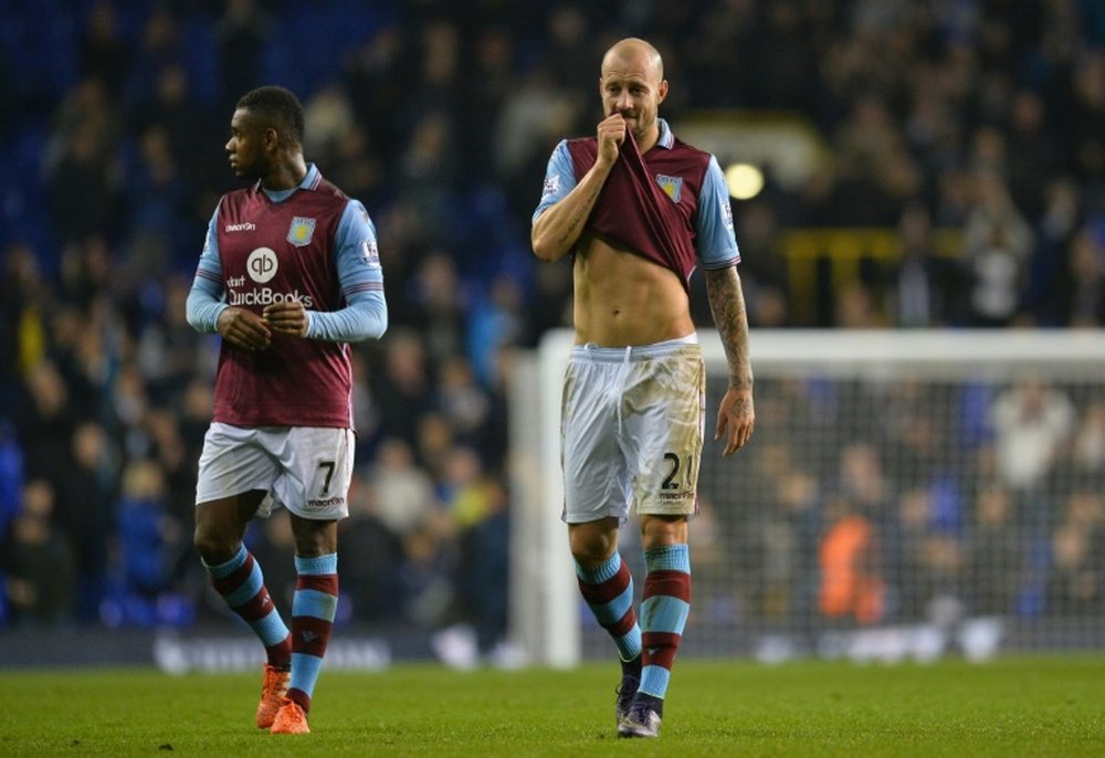 Aston Villas defender Alan Hutton (R) reacts after losing an English Premier League football match to Tottenham Hotspur at White Hart Lane in north London on November 2, 2015