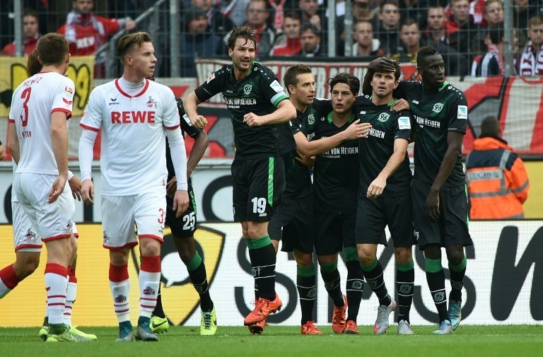 Hannovers players celebrate during a German first division Bundesliga football match against Cologne in Cologne, western Germany, on October 18, 2015