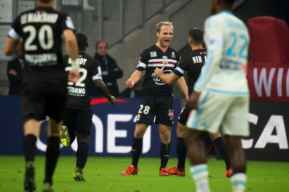 Nices forward Valere Germain (Rear C) celebrates with teammate Hatem Ben Arfa after scoring during a French L1 football match against Marseille on November 8, 2015 at the Velodrome stadium in Marseille, southern France