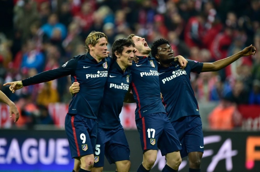 Atletico Madrids players celebrate winning the UEFA Champions League semi-final, second-leg football match between FC Bayern Munich and Atletico Madrid in Munich, Germany, on May 3, 2016