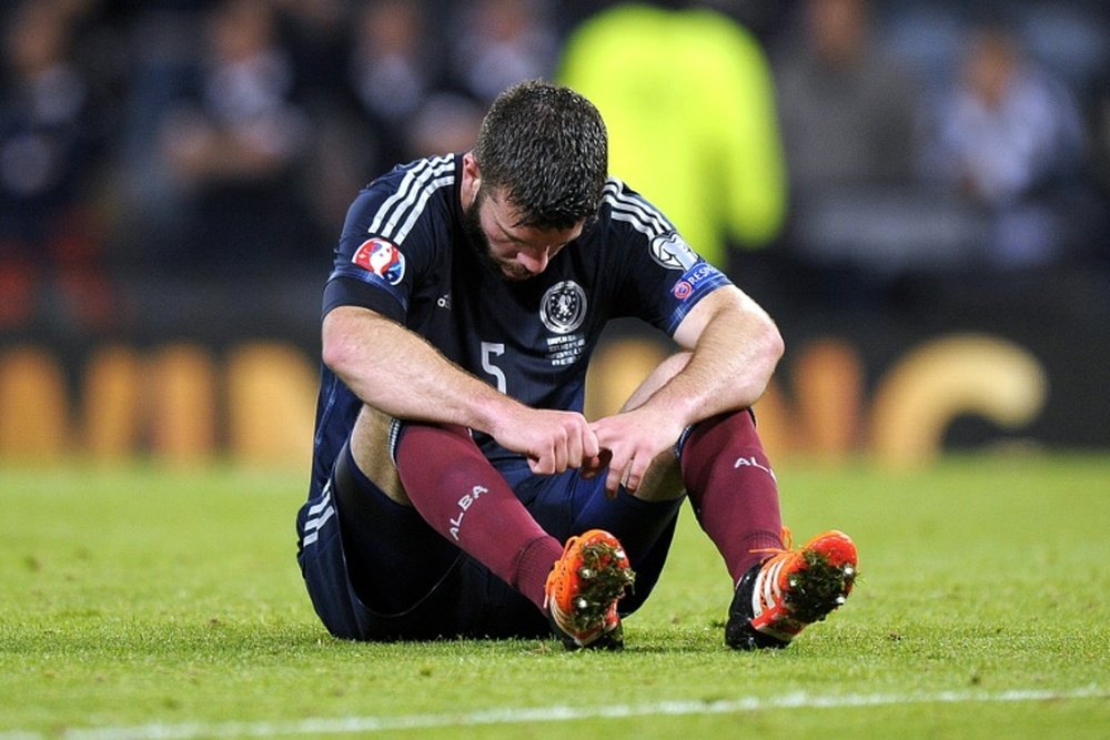 Scotlands Grant Hanley reacts after Poland drew 2-2 at the UEFA Euro 2016 qualifying match between Scotland and Poland in Glasgow on October 8, 2015