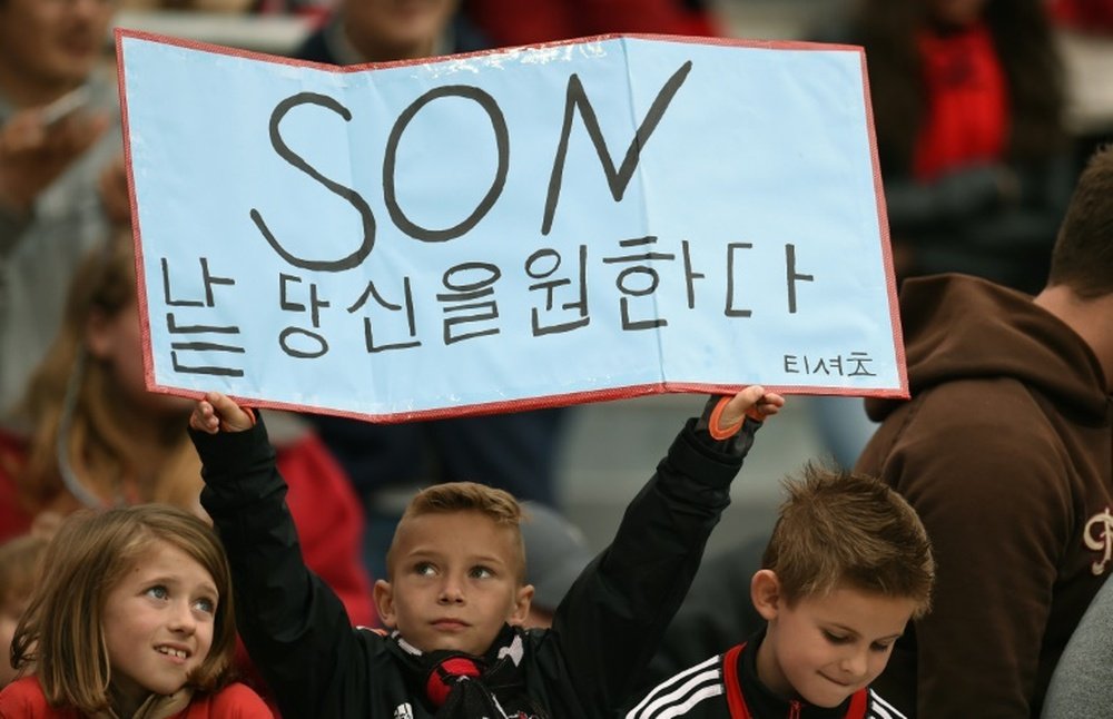 A young fan supports Heung Min Son during Bayer Leverkusens match against Hoffenheim in Leverkusen on May 16, 2015