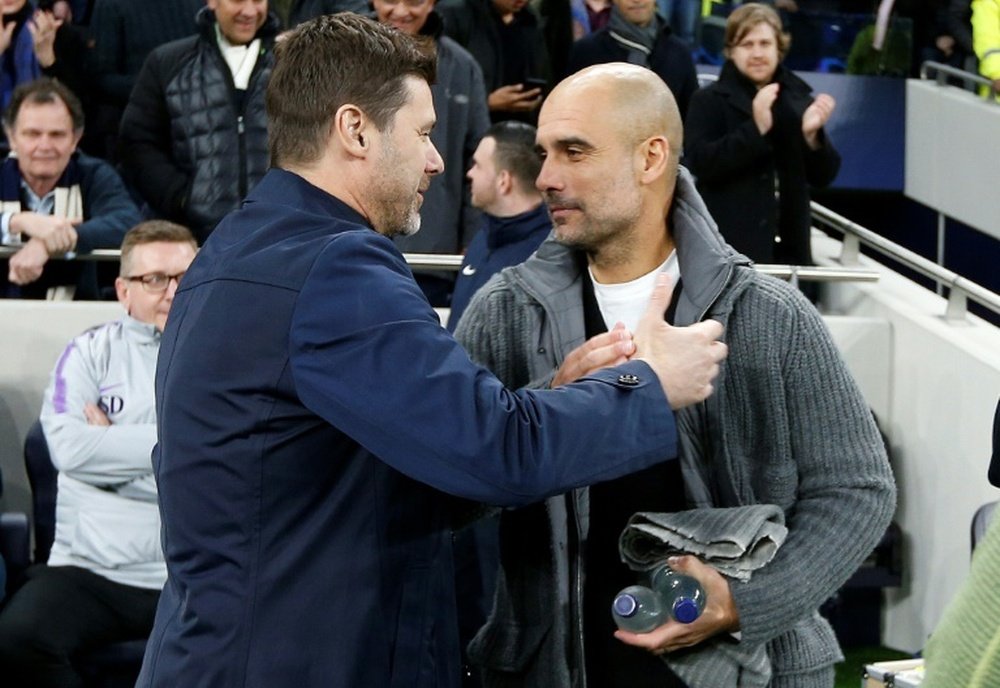 Pochettino greets Manchester City's Pep Guardiola. AFP