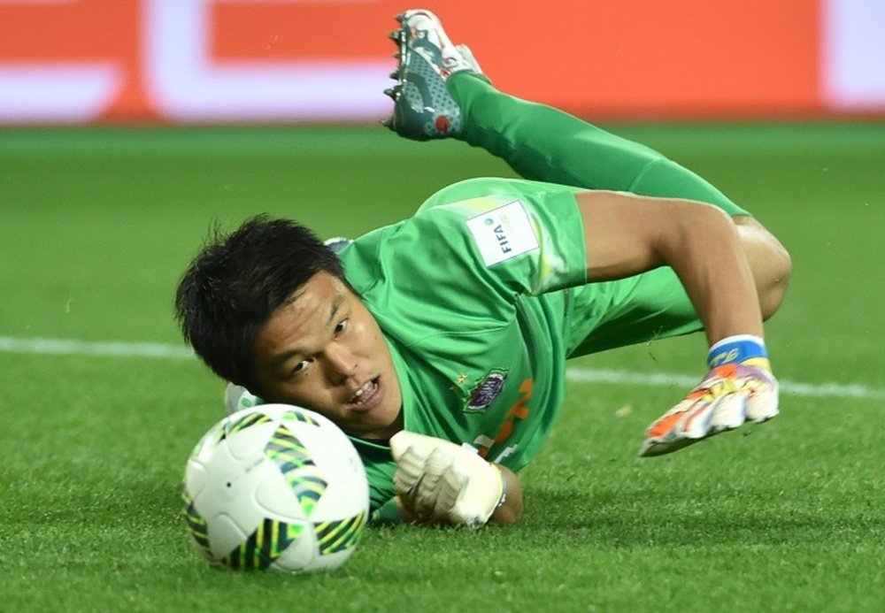 Japans Sanfrecce Hiroshima goalkeeper Takuto Hayashi blocks a shot on December 13, 2015